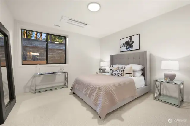 Spacious bedroom on the main level with adjacent full bathroom.