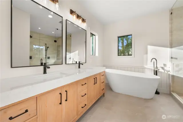 Primary bath includes soaking tub, enormous shower with double fixtures.