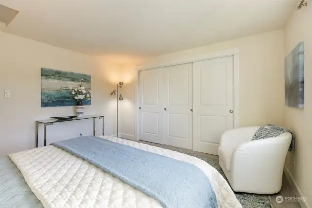 Light-filled primary bedroom features  plenty of closet space.