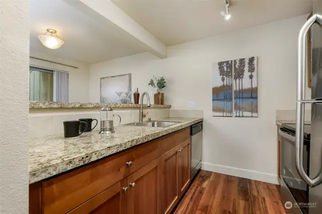 Galley kitchen features plenty of counter and cupboard space.