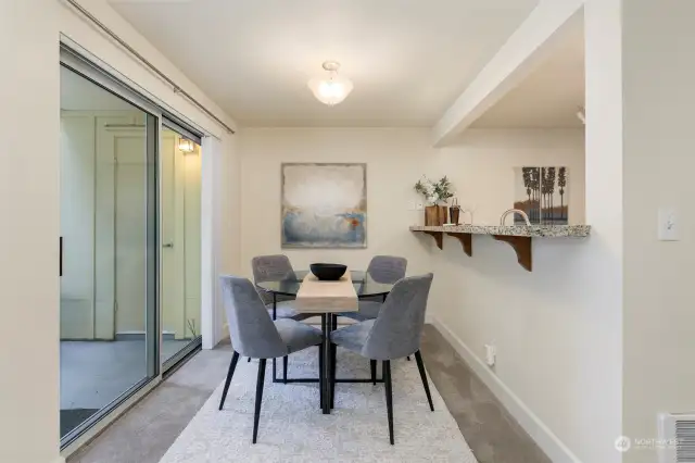 Dining room adjoins private deck with storage room.