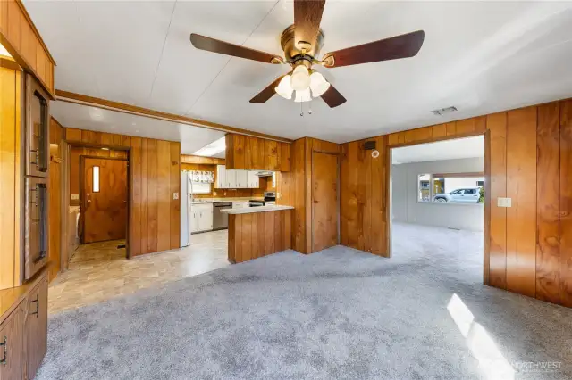 Dining room w/ kitchen in background, liv room to the right & laundry room & back door in the background