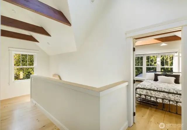View of hall and upper level second bedroom from main bedroom