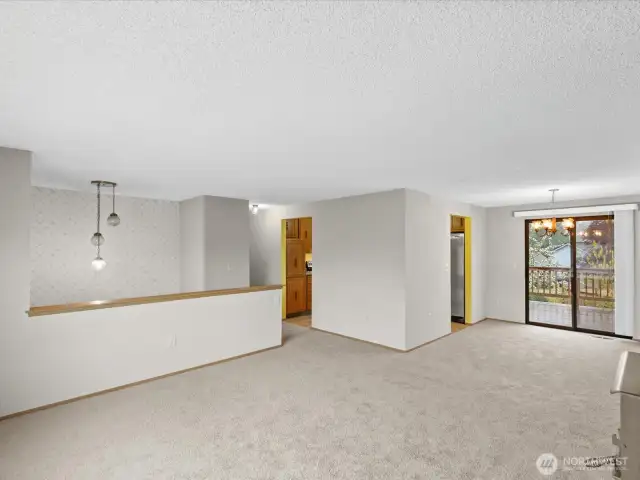 Sliding door leads to deck w/ yard access.