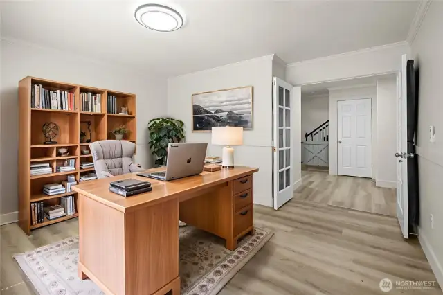 Virtually staged: Glass French doors lead to a large office, with updated trim and chair rail molding. Elegant crown molding in the office and throughout the home.