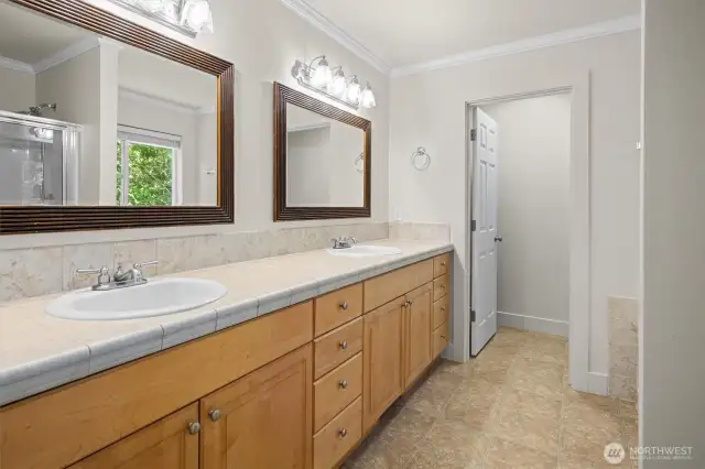Five-piece ensuite bath with a jetted tub, dual sinks, water closet and refreshed cabinets.