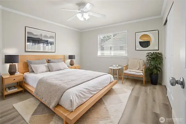 Virtually staged: Second bedroom with crown molding, ceiling fan, and updated LVP flooring and trim