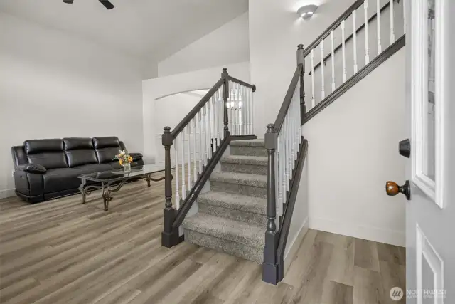 Grand entrance with vaulted ceilings. Updated LVP flooring and 4” craftsman baseboards and casings throughout.