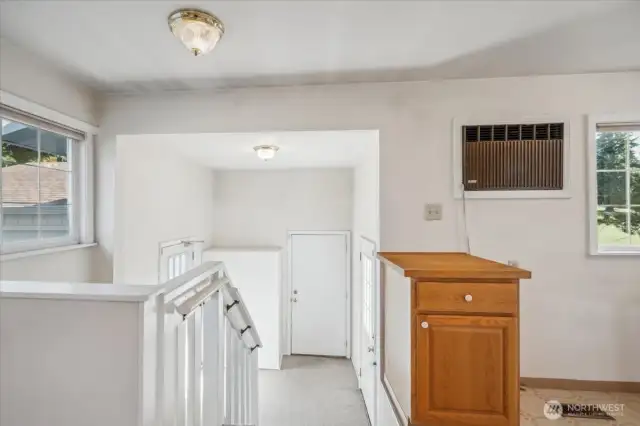 Stairwell off kitchen leading to garage