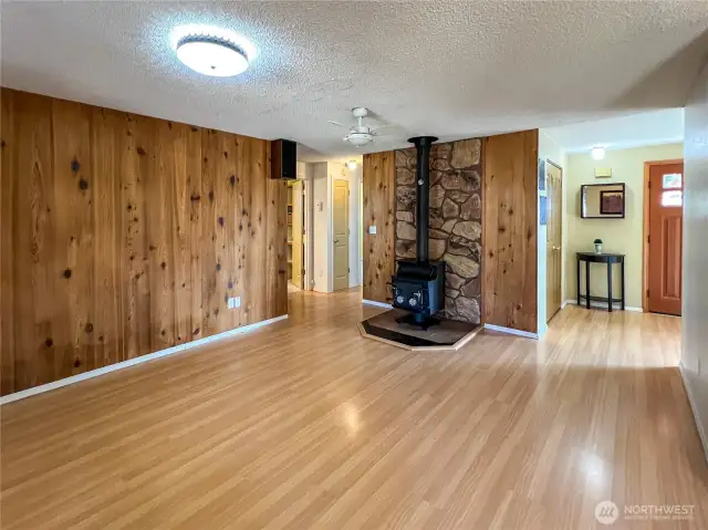 Secondary Living Room with wood burning stove and river rock accent wall