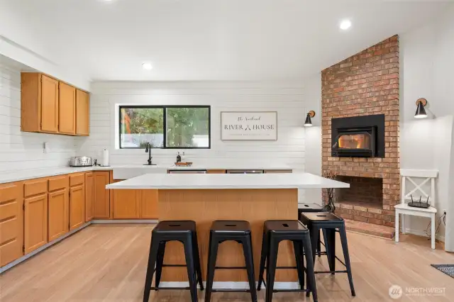 The island anchors an open floor plan that flows seamlessly into dining and living areas