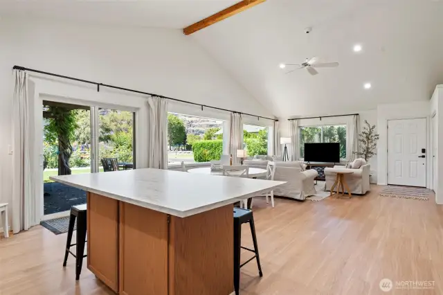 The island bar maintains sightlines to living and dining zones, creating a well functioning space for larger gatherings
