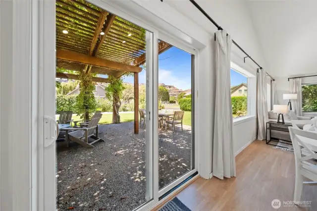 Sliding glass doors frame the lovely transition from great room to covered patio—flooding the space with natural light and offering seamless indoor-outdoor access