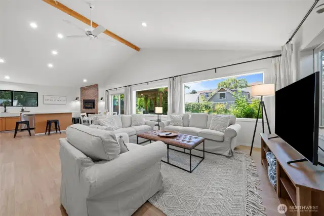 Open floor plan blends kitchen, dining, and living areas in a harmonious layout—accented by airy neutral decor and luxe furnishings