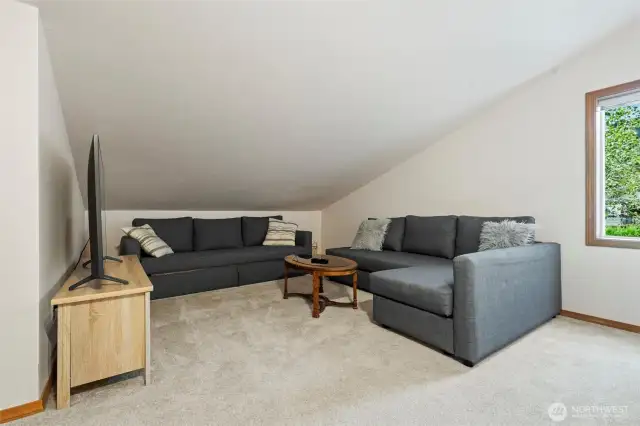 Generously sized loft suite with a comfortable seating area and full bathroom, offering flexibility as a guest suite, home office, or personal sanctuary