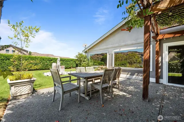 Dine al fresco at this vine-covered gazebo on the spacious rear patio—your shady retreat for refreshing drinks and sunset meals