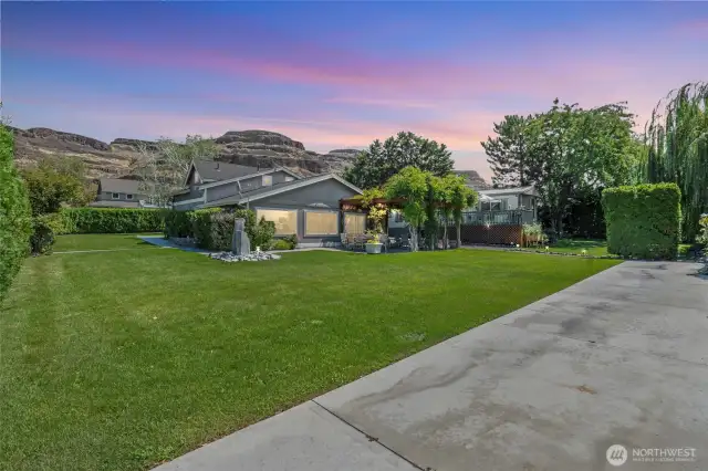 Large, landscaped yard with an RV parking pad and room for toys — ideal for guests, families, or as flexible rental space