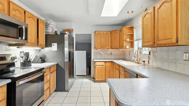Enjoy ample cabinet and counter space and views to sprawling backyard in this kitchen.