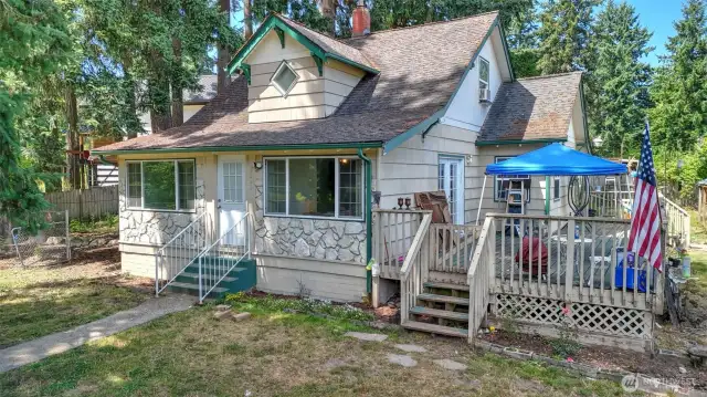 Large deck off the home looks out to the backyard.