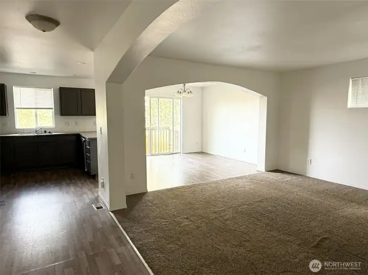 Open concept living area with beautiful arches.