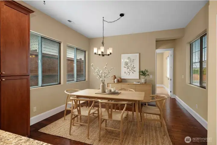 Spacious kitchen featuring a gas range, upgraded 42" cabinets, pull-out pantry shelves, upper and lower recipe windows, and a large eat-in flex space just off the kitchen.