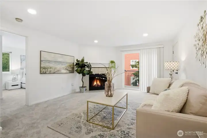 Bright and inviting living room with fresh paint, updated flooring, and a cozy wood-burning fireplace.