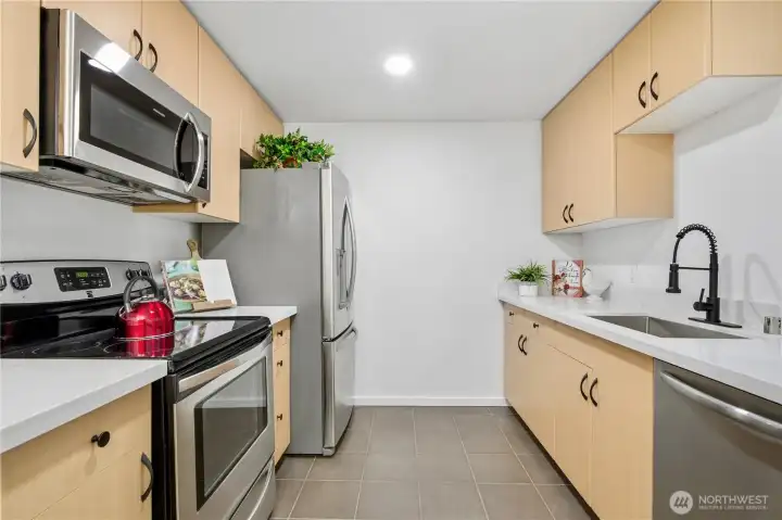 Updated kitchen featuring new countertops and modern finishes.