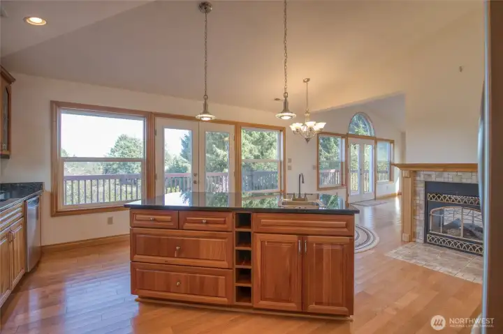 Kitchen Island with a wall of bright windows and doors