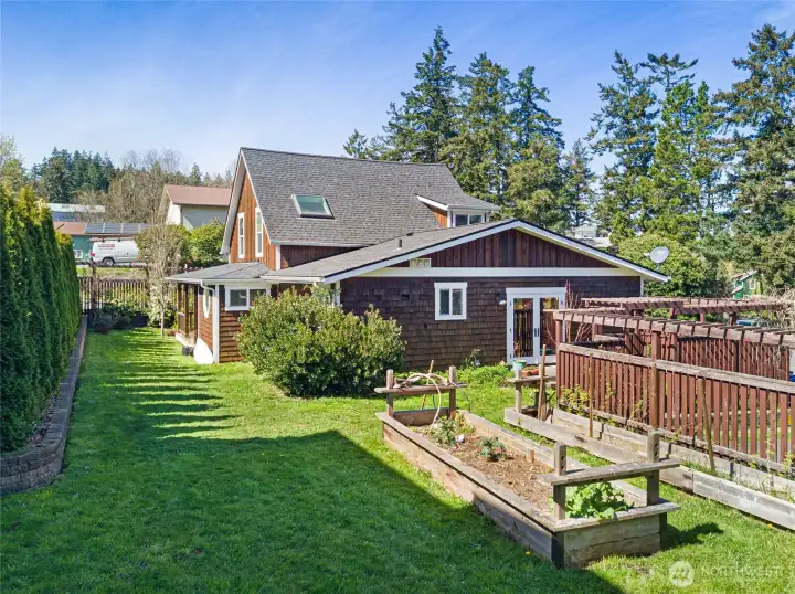 Back side of the home showing the garden area with irrigation.