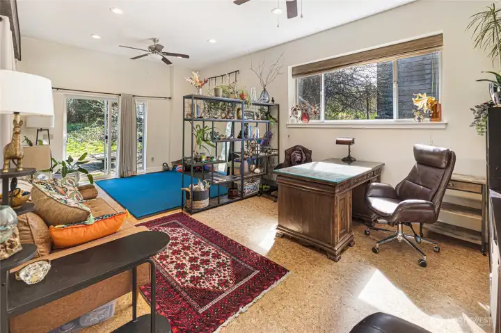 Interior of converted garage. Cork flooring and spacious area.