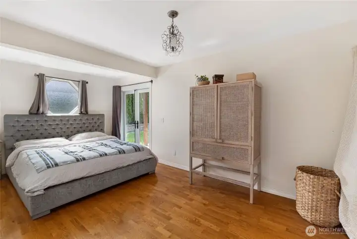 Primary bedroom on the main level. French doors to the covered deck.