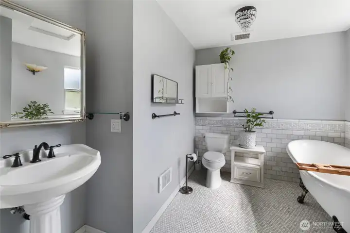 A classy primary bathroom with heated tile floors