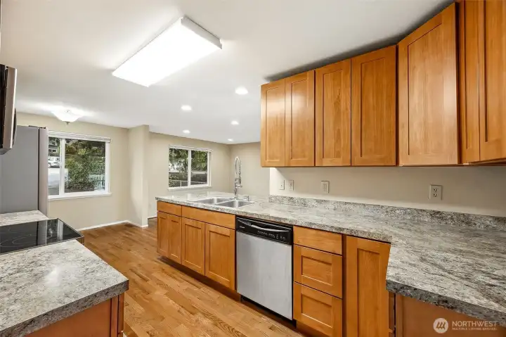 Remodeled kitchen with stainless steel appliances, solid wood cabinetry, ample counter space, and a functional layout ideal for cooking and hosting