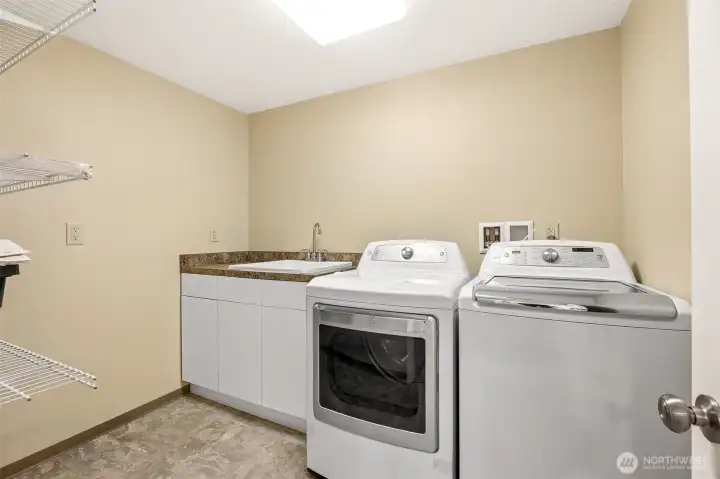 Convenient in home laundry area with washer/dryer, storage options, and easy access from the main living spaces