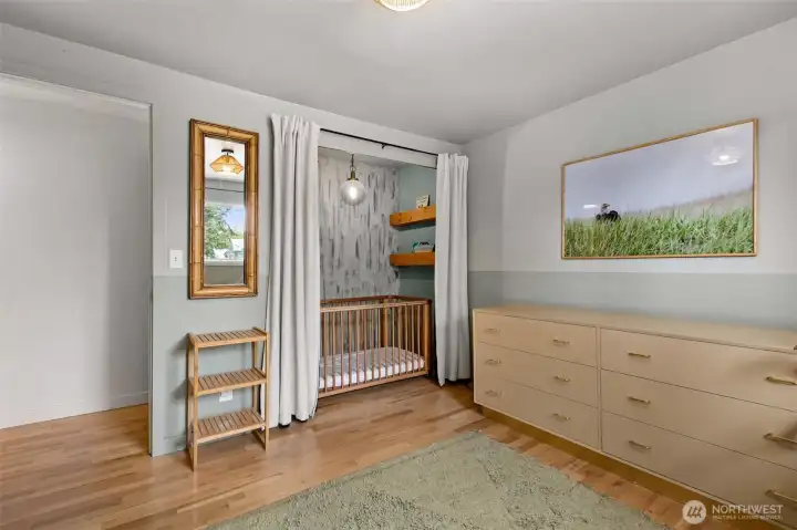 Second bedroom on main floor. Note the clever crib space in the closet.