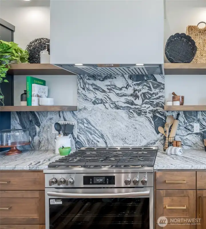 Granite backsplash over the 6 burner stove and combo oven/air fryer