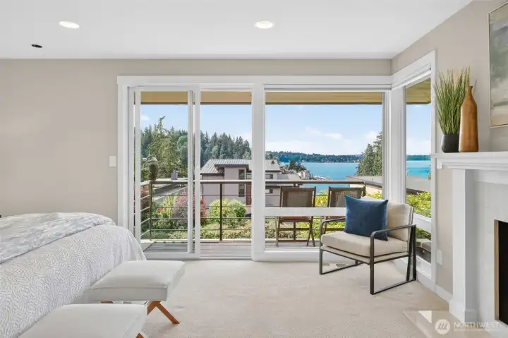 Step directly from bed onto the private deck   and let Lake Washington do the rest —   morning coffee has never had a better   setting, with the Cascade foothills stretching   across the water and the Ohashi garden   below in full color.