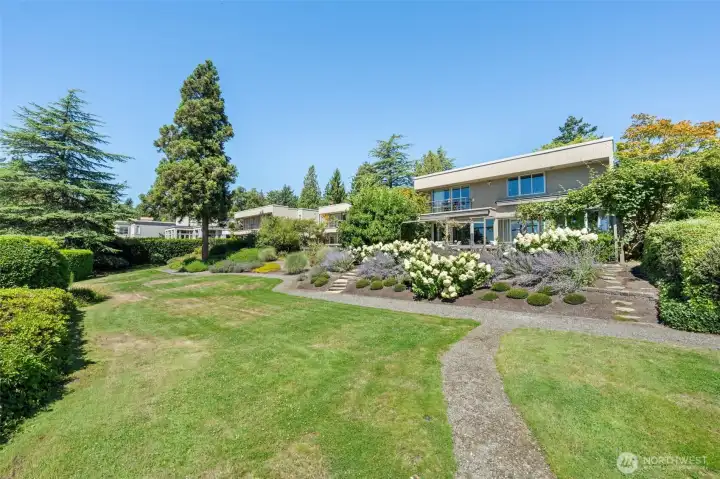 The shared community lawn that borders the   property adds a rare sense of openness and   breathing room that private lots simply can't   replicate — a park-like setting right at the   back garden's edge.