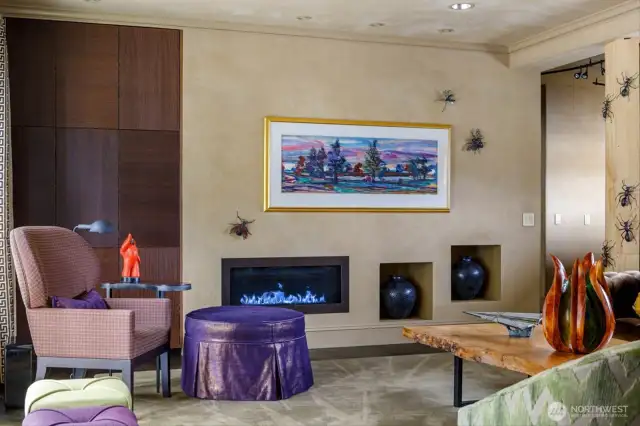 Enjoy surround sound and a linear gas fireplace, framed by Venetian textured plaster, creating an intimate and warm ambiance.