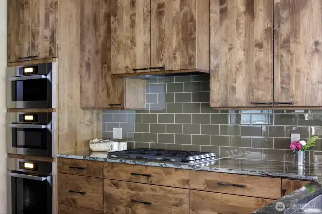 Richly adorned with marble, metals, handmade glass, fine textiles, and custom DeWils knotty alder cabinetry, the interior showcases timeless design.