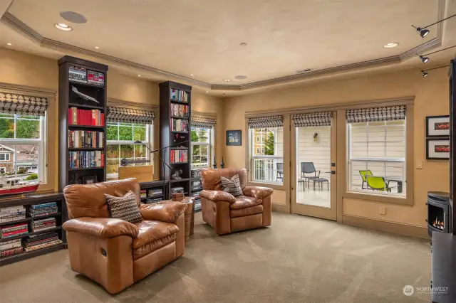 After a day at the beach, unwind in your media room with its crystal cabinetry featuring bronze handles and marble-topped closet cabinets.