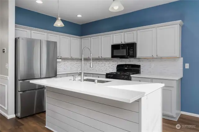 Updated kitchen with granite countertops and backsplash