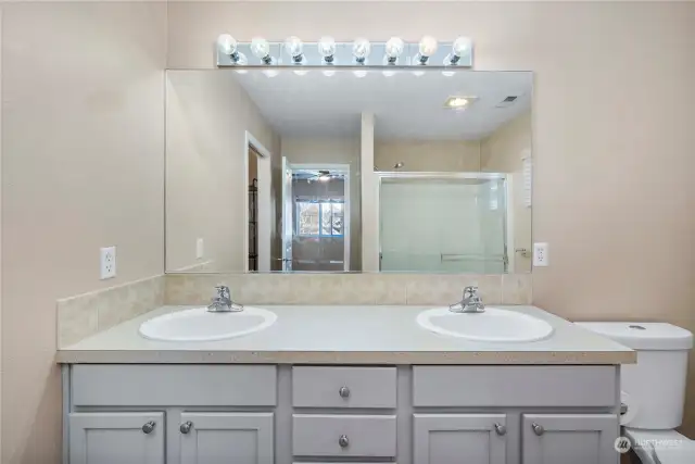 Primary bathroom with double sinks and large walk-in shower