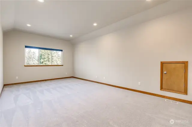 Large bonus room upstairs with convenient attic storage access