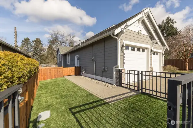 Fully-fenced dog run with artificial turf and sprinklers for easy cleanup!