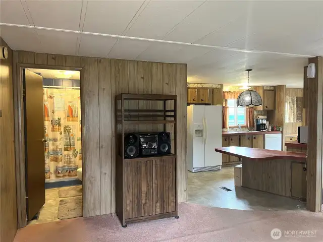 Viewing from the office/den, open to kitchen and full bathroom.