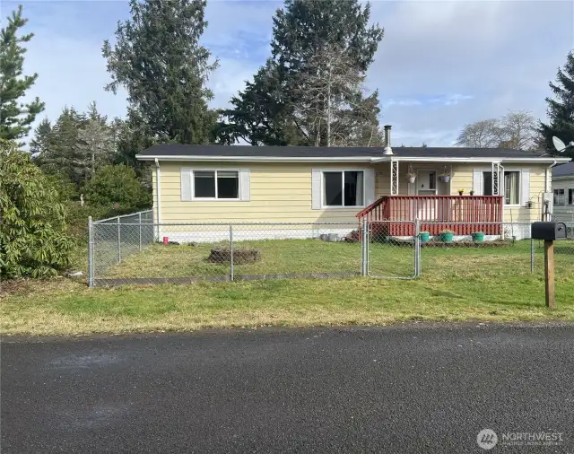 Front of house with front porch and fenced yard.  Close to shopping, eateries, Ocean, golf course and Willapa Bay.
