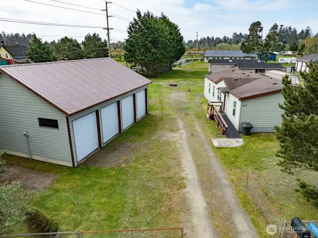 Mixed-Use Zoned 3-bedroom home and shop with a fully fenced .31 acre yard has a 1200 square foot 4 bay shop with a 100 amp service for all your toys or projects, plus an RV hookup