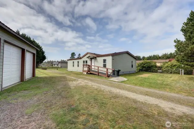 Mixed-Use Zoned 3-bedroom home and shop with a fully fenced .31 acre yard has a 1200 square foot 4 bay shop with a 100 amp service for all your toys or projects, plus an RV hookup