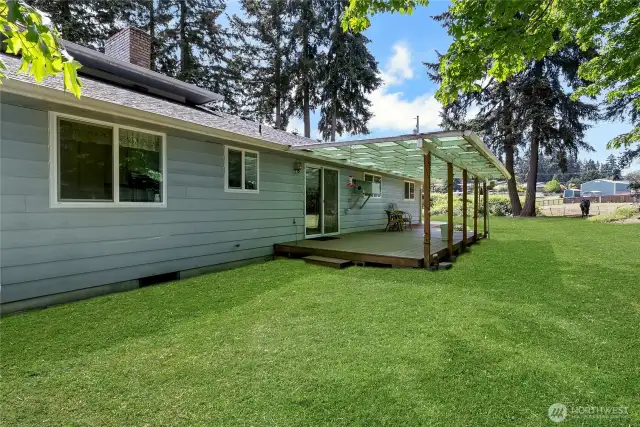 View of covered deck and view of neighboring pasture. He boards 2 horses. They like to visit for apples.